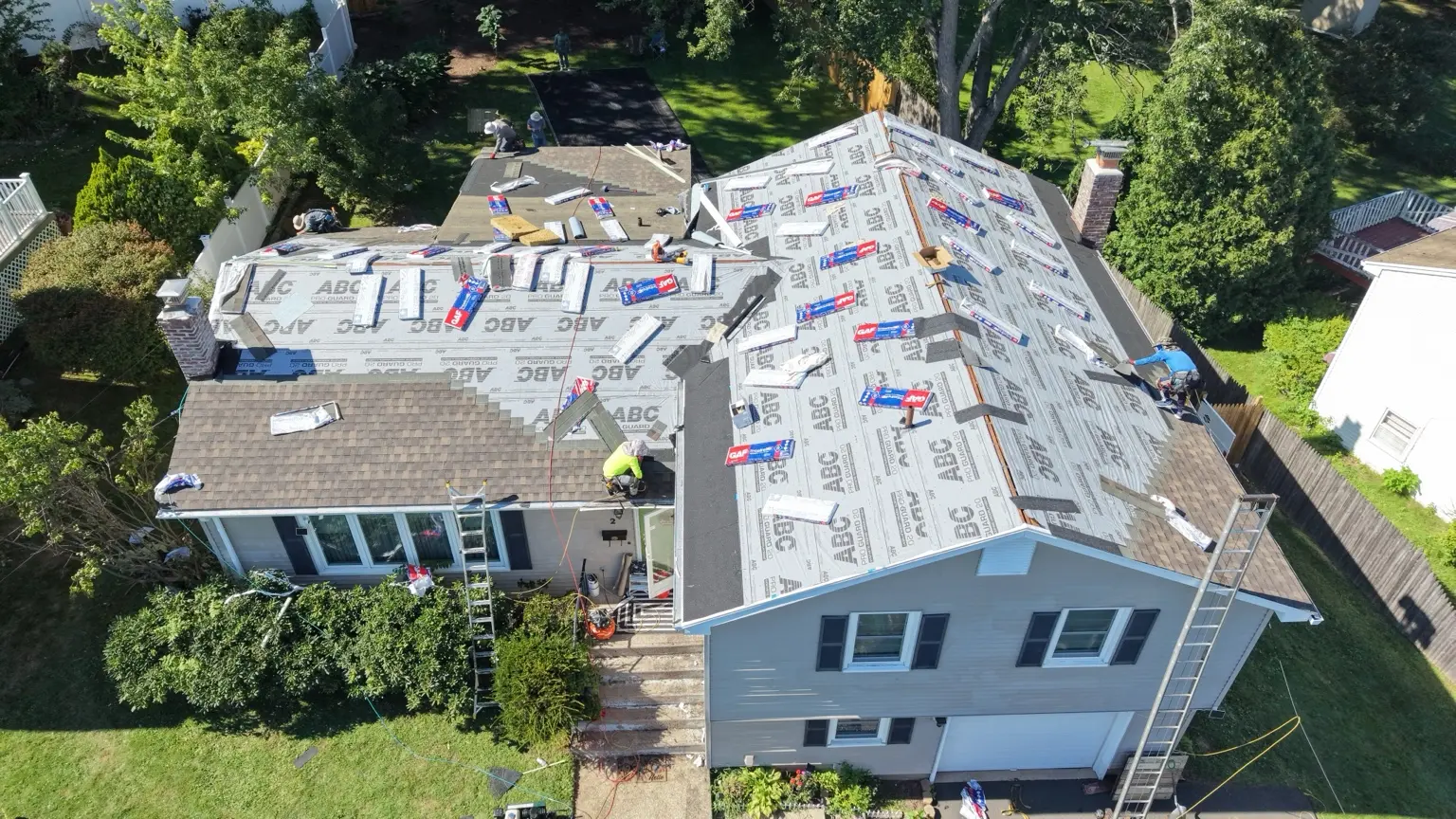 Architectural shingle installation in progress.